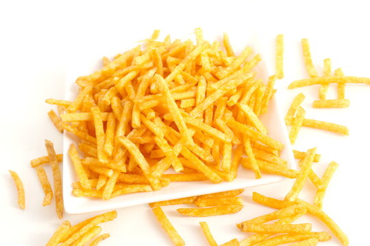 There are potato chips cut into strips in a ceramic plate.