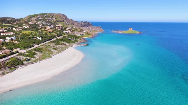 Aerial pull back view revealing La Pelosa beach with turquoise water and white sand coastline in Sardinia, Italy