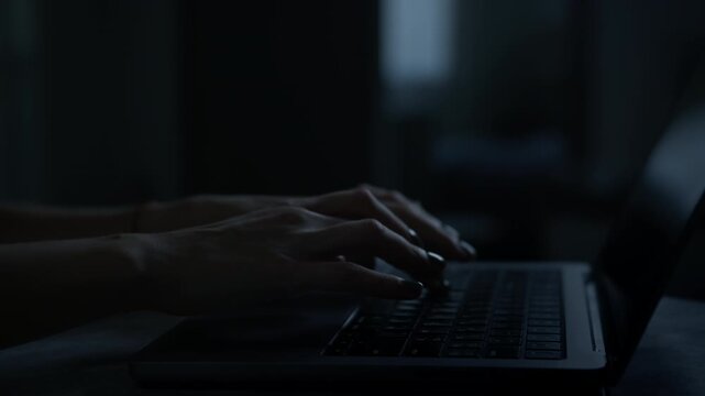 Typing on Laptop in Dark Room
