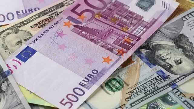 Close up motion shot spinning background Euro and US Dollar currency banknotes. Financial industry investment banking global economy wealth success cash money concept.