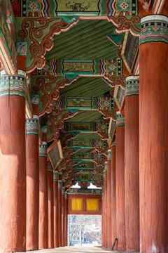 Traditional Korean hanok architecture with colorful dancheong patterns and wooden pillars showcasing detailed heritage design and interior structure.