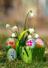 easter eggs in the grass in a green basket
