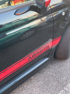 Black ABARTH 500 car side with striking red racing stripes and mirror detail at Strada Provinciale di Bardi, Castell'Arquato, Emilia Romagna, Italy