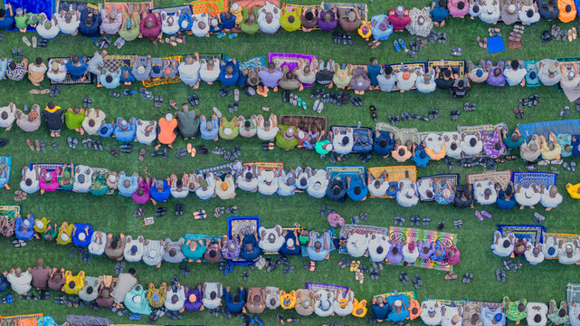 Lagos, Nigeria - 20 March 2026: Aerial view of faithful worshippers gathered on vibrant mats over lush green grass, creating a mosaic of devotion and community under the open sky.