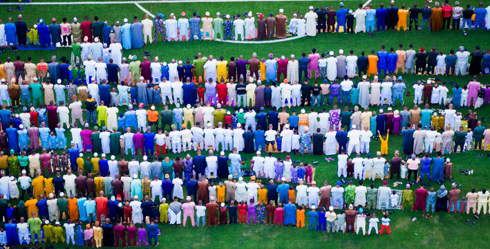 Lagos, Nigeria - 20 March 2026: Aerial view of a large group of people gathered on a green field, their colorful garments creating a vibrant mosaic against the grass.