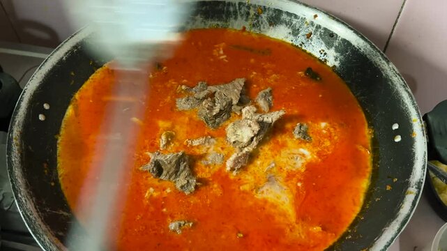 The process of cooking beef rendang with traditional Indonesian spices. A legendary culinary spice from Padang.