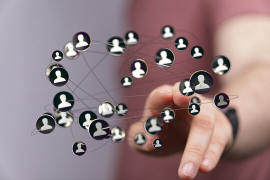 Concept of social networking and teamwork. Hand touching a digital network of people, representing connections and glob