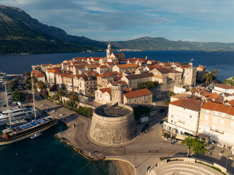 Aerial view of the ancient stone fortress and terracotta rooftops meet the azure sea, a timeless scene of history and beauty, Korcula, Dubrovnik-Neretva County, Croatia.