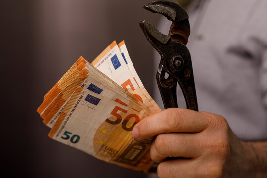 Concept of financial restriction or control visualized with pliers squeezing Euro banknotes, money m
