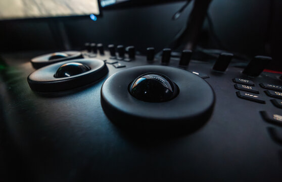 Color grading control surface with trackballs in dark post-production studio