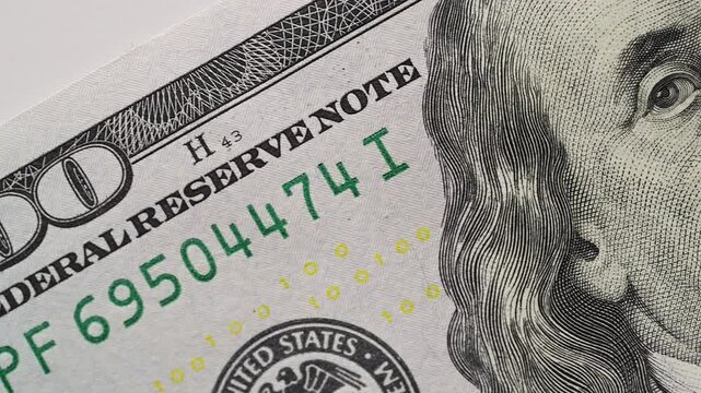 Macro slide camera shot US dollar banknote security details. Visible paper texture blue holographic ribbon liberty bell. Financial market banking treasury reserve economy savings success concept scene