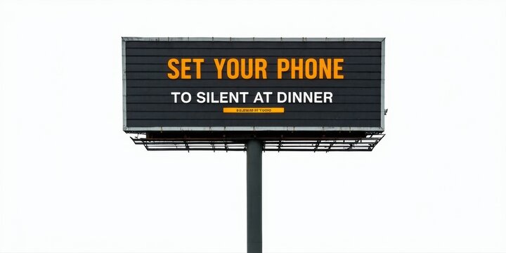 Billboard displays message requesting phone silence during dinner. Simple design, dark background, orange text. Minimalist aesthetic.