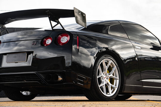 Black Nissan GT-R rear quarter low angle, High performance sports car external shot outdoors