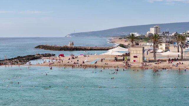 Aerial View of Nahariya Beach and Promenade with Turquoise Sea and Breakwater, Israel