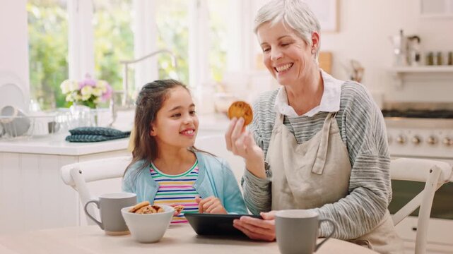 Tablet, grandma and child with cookies and tea for sweet treat, watching movie or bonding in home. Eating, granny and girl kid with biscuits in beverage for dessert, weekend visit and streaming film