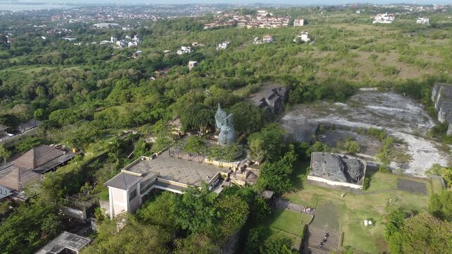 Aerial drone orbiting right above Plaza Wisnu at Garuda Wisnu Kencana Cultural Park in Bali, Indonesia.