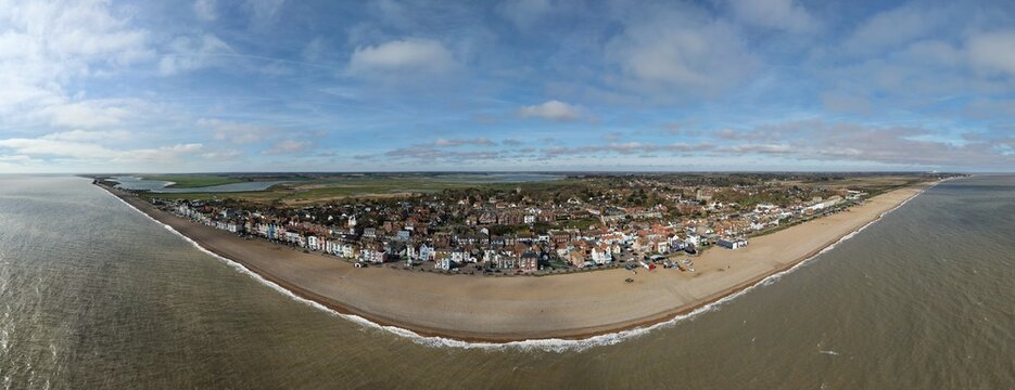 Aerial view of where the North Sea embraces the sandy shore and charming buildings of Aldeburgh, Suffolk, England, United Kingdom.