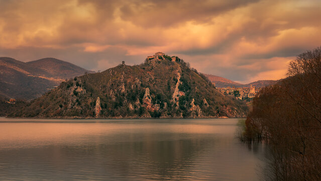 Panoramic View of a Hilltop Town Reflected in Calm Lake Waters