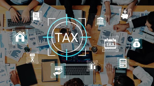 Business Team Discusses Tax Planning Strategies with Charts, Graphs, and Financial Data on Table during Meeting in Office Environment Gluon.
