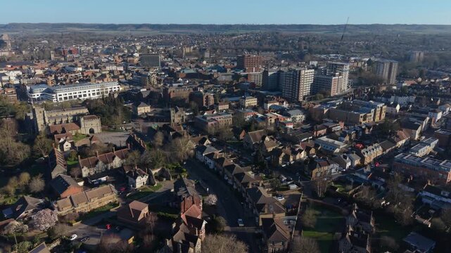 Panoramic with of Maidstone town and historic Archbishop's Palace by the river Medway in Kent, UK. Arial sideways motion above the town on a sunny morning. High rise buildings in town center.