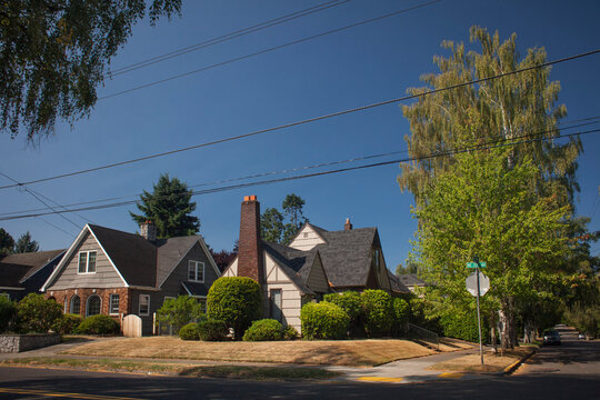 19th-century architecture on a street corner of the residential Lloyd District neighborhood under a clear blue sky in Portland, Oregon