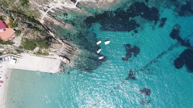 Colourful Pedal Boat on the shoreline. Overhead aerial view from drone
