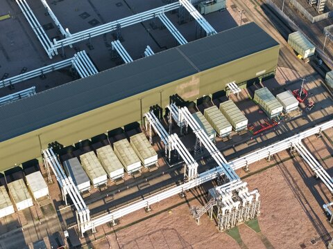 Aerial view of industrial architecture casting shadows with its metallic texture, National Grid Bramford 400kV Substation, Ipswich, United Kingdom.