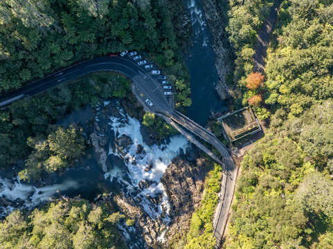 Aerial view of the tranquil McLaren Falls amidst lush forests and the rushing waterfall, Lower Kaimai, Bay of Plenty Region, New Zealand.