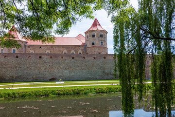 Fototapeta premium Fagaras Fortress surrounded by water in the city of Fagaras, Transylvania, Romania
