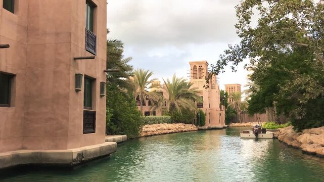 Madinat Jumeirah Dubai traditional Arabian architecture and waterways glowing at golden hour sunset UAE