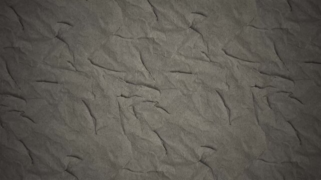 Textured dark brown paper background showing subtle folds and creases