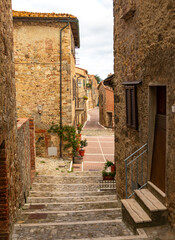 Obraz premium Stone steps descending into narrow Castiglione d'Orcia street, Tuscany, Italy.