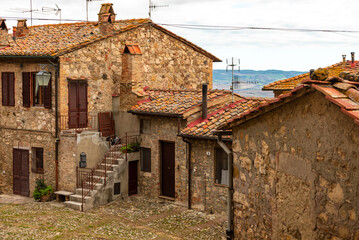 Obraz premium Traditional stone buildings on an old street in Castiglione d'Orcia, Tuscany, Italy.