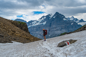 Fototapeta premium Sporty woman hiking in Switzerland alps. Heathy lifestyle, sport, beauty in nature. Grindelwald valley, Swizz