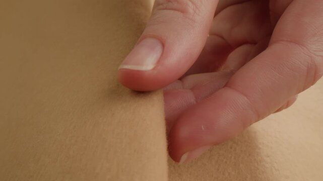 Beige wool background, natural sheepskin close-up macro coat. Top view