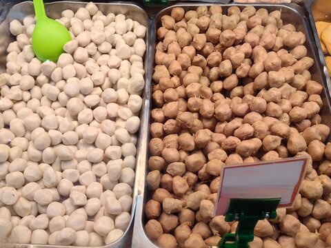 Frozen beef meatball and fish meatball on countainer food in meat market.