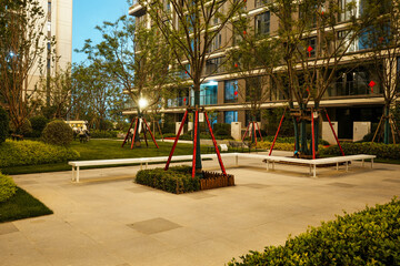 Modern garden plaza with white benches and lush trees - Serene urban concept © syu