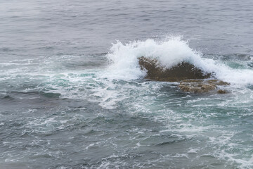 Fototapeta premium Atlantic Ocean Wave Crashes Over Small Rock