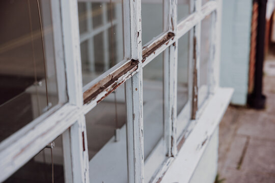 Weathered wooden window frames with peeling paint detail