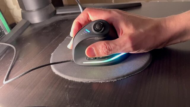 User demonstrates mouse control on a desk with RGB lights at night