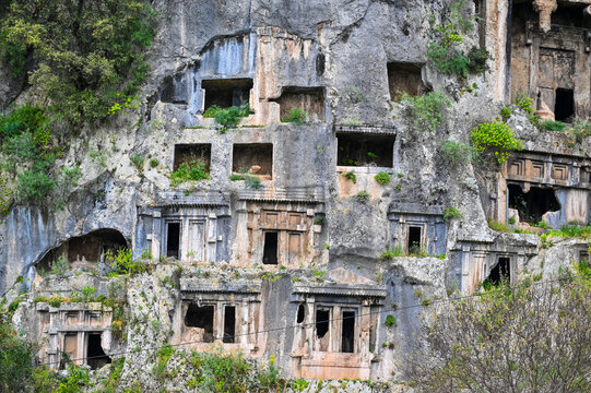 Fethiye Rock Tombs on Cliff with Green Vegetation &ndash; Ancient Lycian Telmessos Ruins in Turkey
