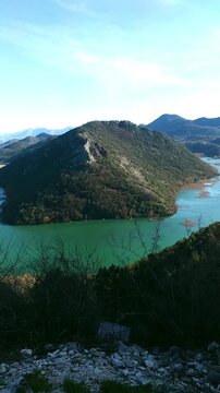 View of meandering Crnojevića river forming dramatic loop through green landscape at Pavlova Strana. Represents fluvial geomorphology, natural landscape patterns, and terrain-driven water dynamics.