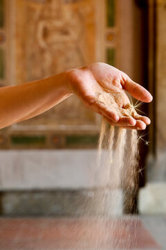 Sand Falling Through Hand Symbolizing Time Passing, Loss and Impermanence