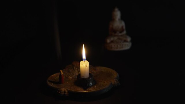 Candle and Buddha statue
