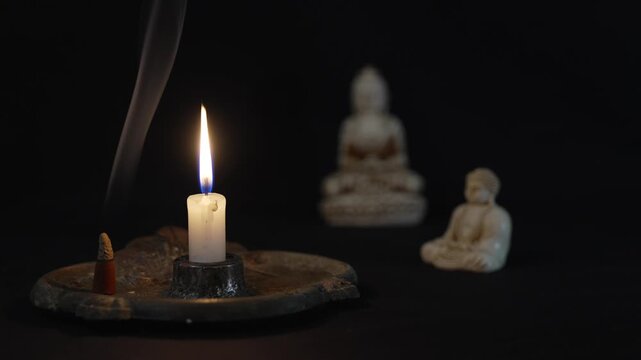 Candle and Buddha statue