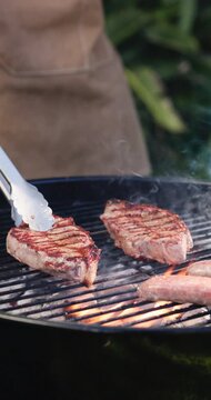 Food, barbecue and hands of people with meat for social gathering, party and hangout together in summer. Fire, cookout and steak with flames for bbq for holiday, celebration and reunion on weekend