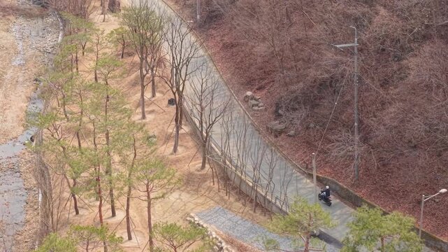 Cinematic motorcycle riding on Scenic route with a mountain creek with synchronized real exhaust sound_Telephoto