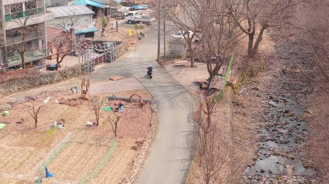 Cinematic motorcycle riding on Scenic route with a mountain creek with synchronized real exhaust sound_Telephoto