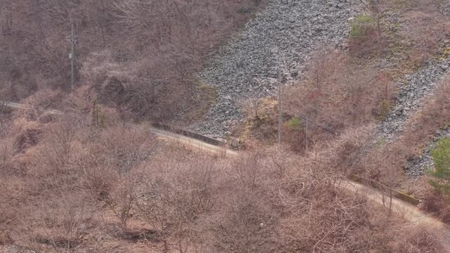 Cinematic motorcycle riding on Scenic route with a mountain creek with synchronized real exhaust sound_Telephoto