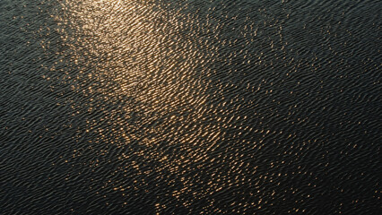 Glittering River Water Waves at Sunset.